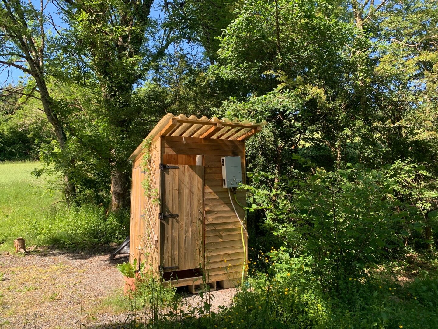 Houten sanitairhokje tussen de bomen
